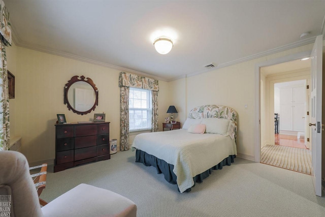 bedroom featuring ornamental molding and light carpet