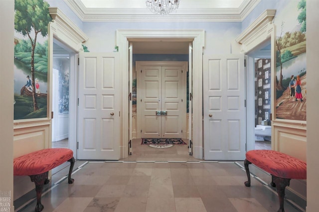 interior space with a notable chandelier, ornamental molding, and light tile floors