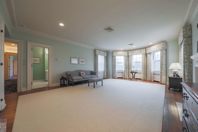 interior space with a fireplace, radiator heating unit, dark hardwood / wood-style flooring, and ornamental molding