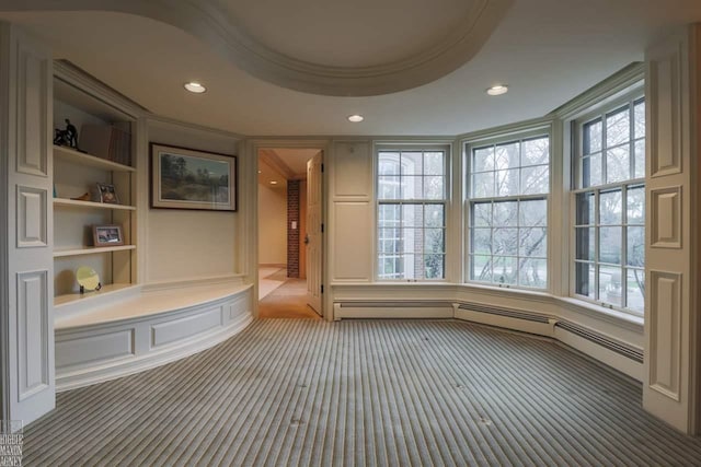 mudroom featuring a raised ceiling and built in shelves