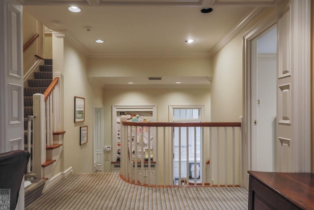 hallway featuring crown molding and carpet floors