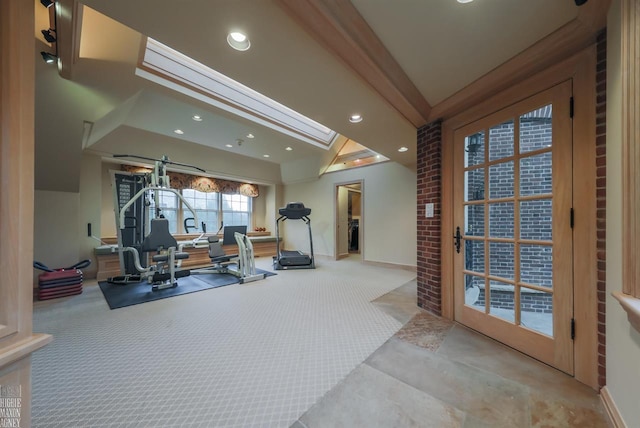 workout area featuring brick wall and light colored carpet