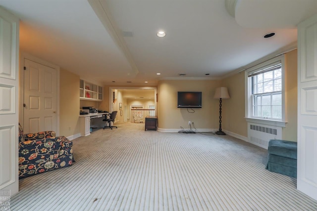 unfurnished living room with radiator heating unit and light colored carpet