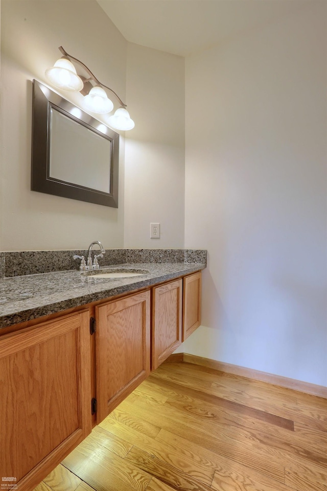 bathroom with vanity and hardwood / wood-style flooring