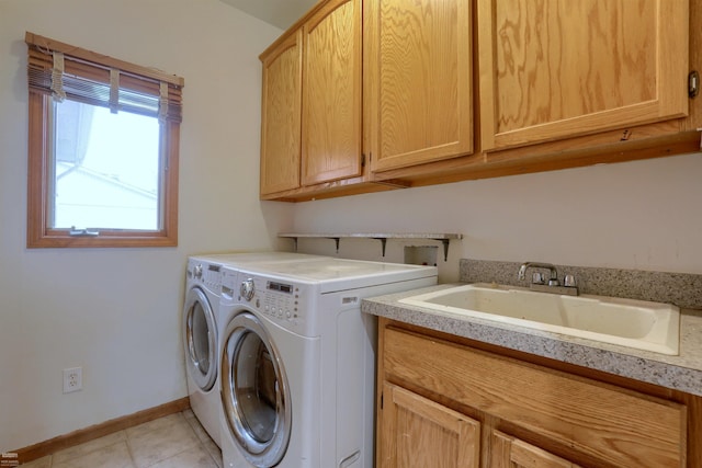 laundry area featuring light tile floors, independent washer and dryer, sink, cabinets, and washer hookup