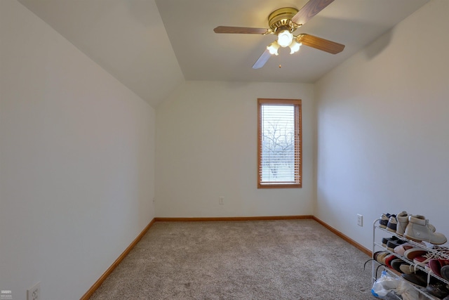 spare room with light colored carpet, ceiling fan, and lofted ceiling