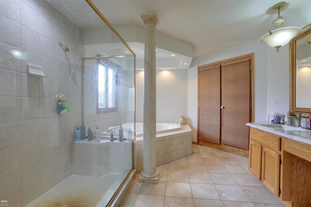 bathroom featuring shower with separate bathtub, vanity, decorative columns, and tile floors