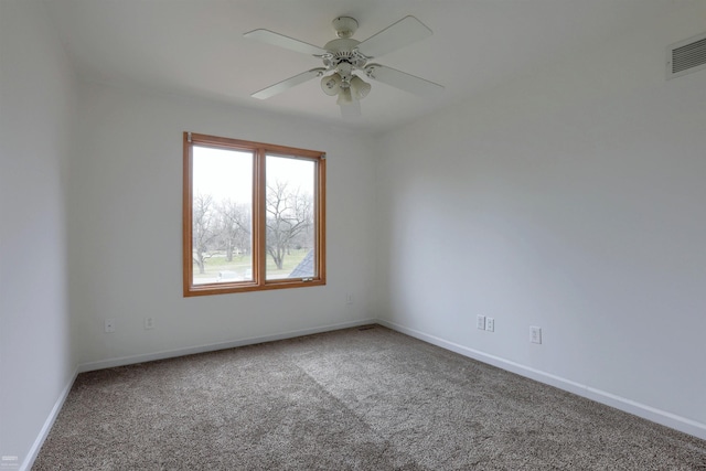 carpeted spare room featuring ceiling fan