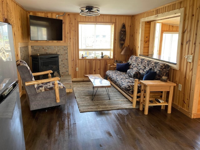 living room featuring dark hardwood / wood-style floors and wood walls