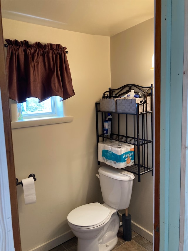 bathroom featuring tile floors and toilet