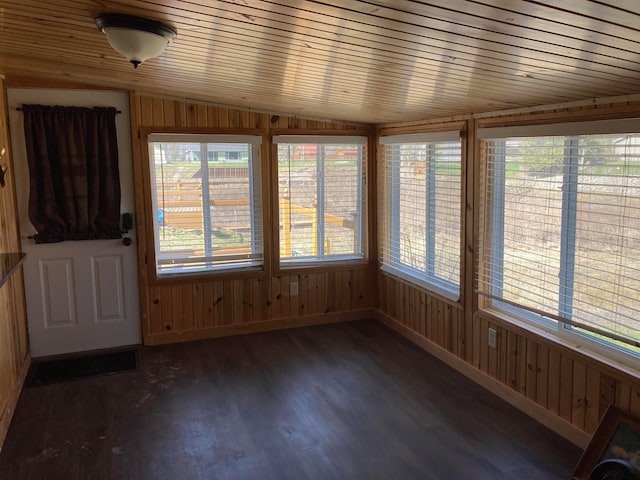 unfurnished sunroom with wooden ceiling, plenty of natural light, and lofted ceiling