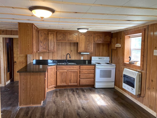 kitchen with white electric stove, wood walls, sink, and dark wood-type flooring