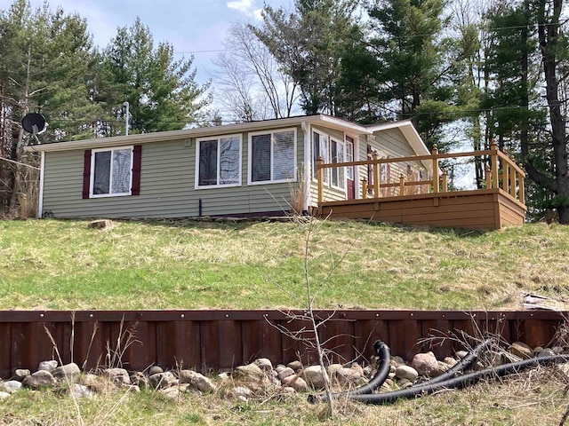 exterior space with a lawn and a wooden deck