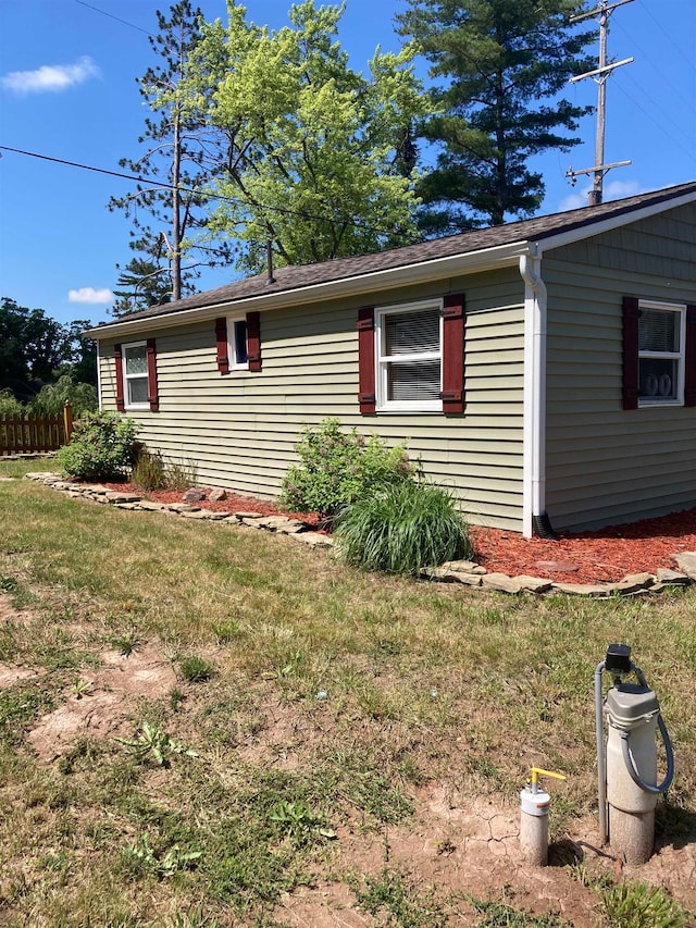 view of side of property featuring a yard