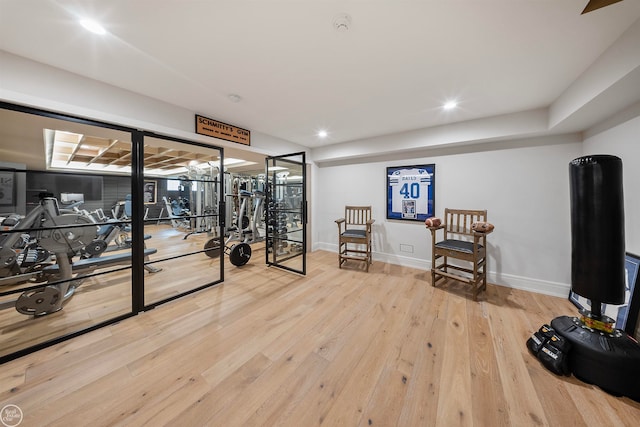 exercise area with light wood-type flooring