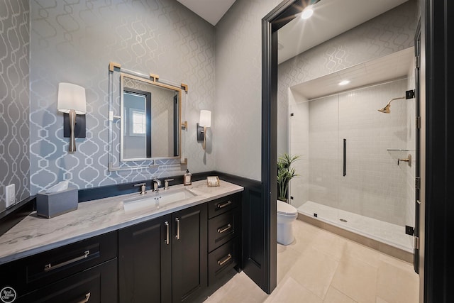 bathroom with walk in shower, vanity, toilet, and tile floors