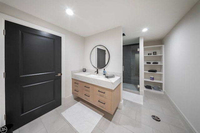 bathroom with tile flooring, vanity, and a shower with door