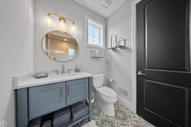 bathroom featuring vanity with extensive cabinet space, tile flooring, and toilet