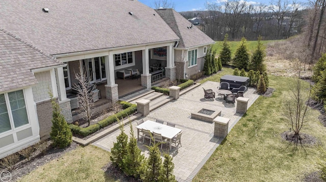 exterior space featuring a patio, an outdoor living space, and a lawn