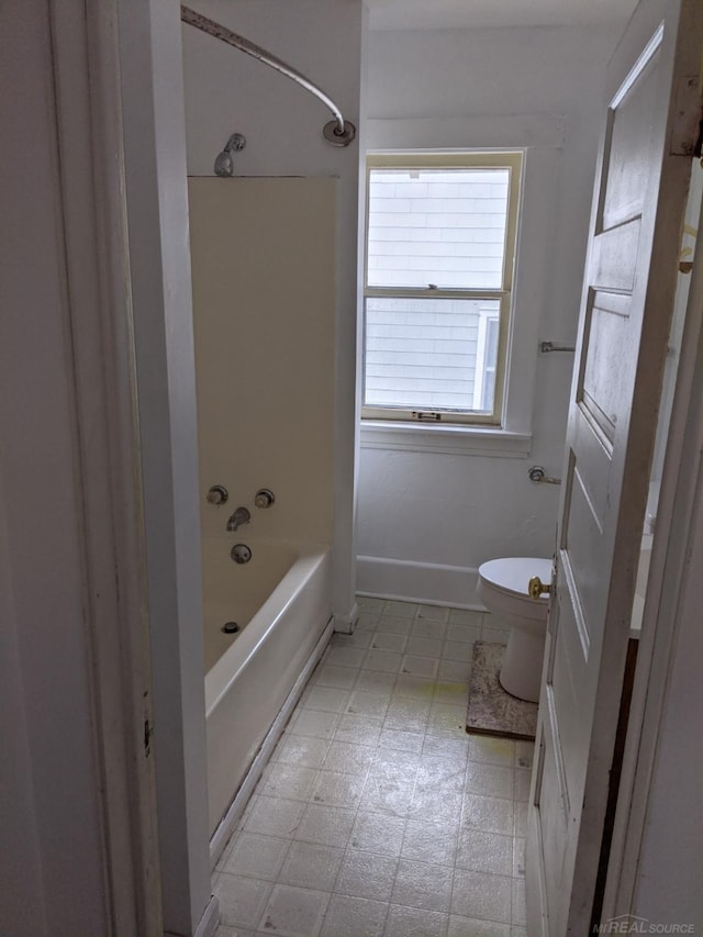 bathroom with toilet, tile flooring, and shower / bathtub combination