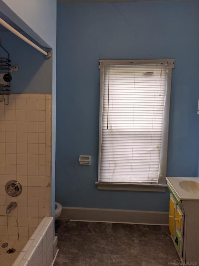 bathroom with tile floors, vanity, and toilet