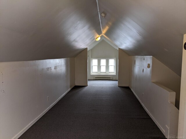 bonus room with lofted ceiling, dark carpet, and a baseboard heating unit