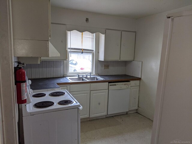 kitchen featuring white cabinets, sink, white appliances, and light tile floors