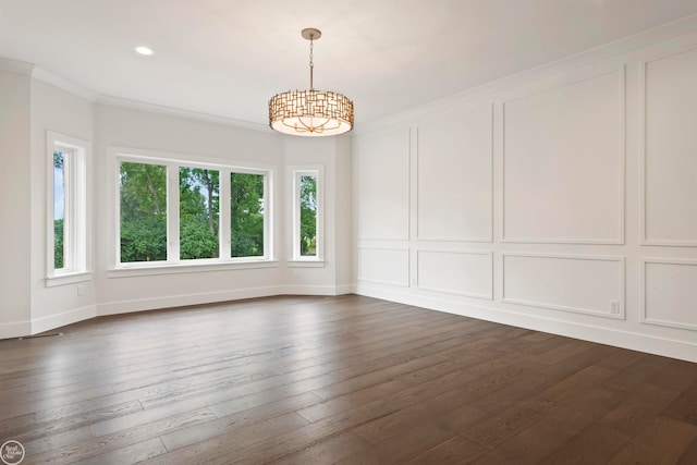 spare room with ornamental molding and dark hardwood / wood-style flooring