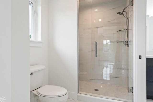 bathroom featuring an enclosed shower and toilet