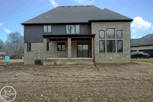 rear view of house featuring central AC unit