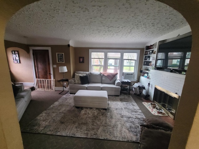 carpeted living room with built in shelves, a textured ceiling, and a fireplace