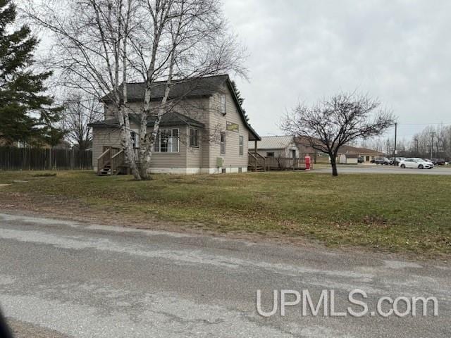 view of side of home featuring a lawn