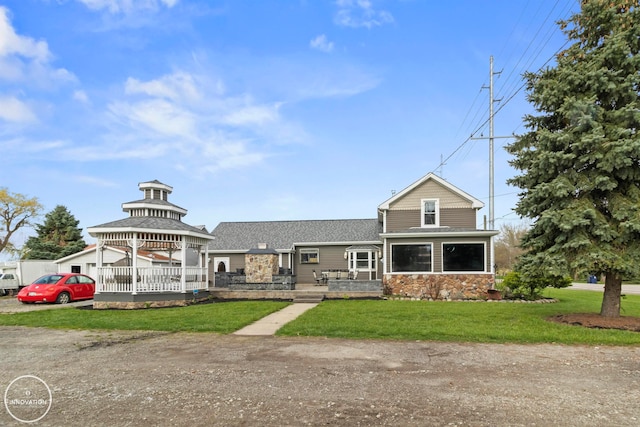 view of front facade featuring a front yard and a gazebo