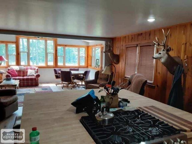 dining area featuring wood walls and hardwood / wood-style flooring