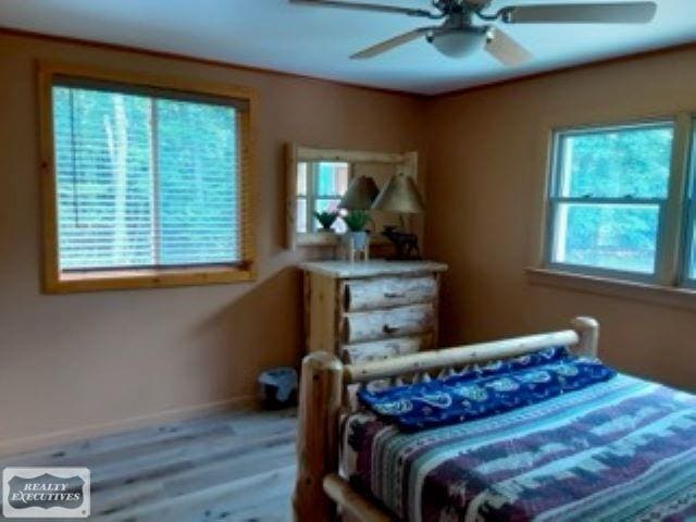 bedroom featuring wood-type flooring and ceiling fan