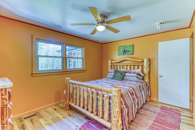 bedroom with wood-type flooring and ceiling fan