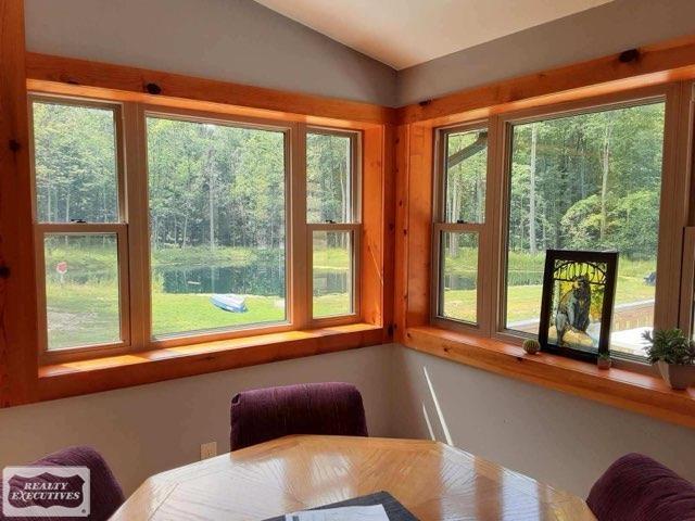 sunroom featuring lofted ceiling