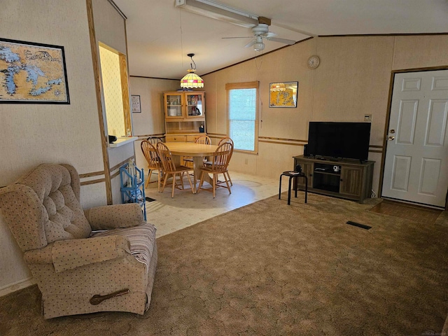 living room featuring carpet, ceiling fan, and lofted ceiling