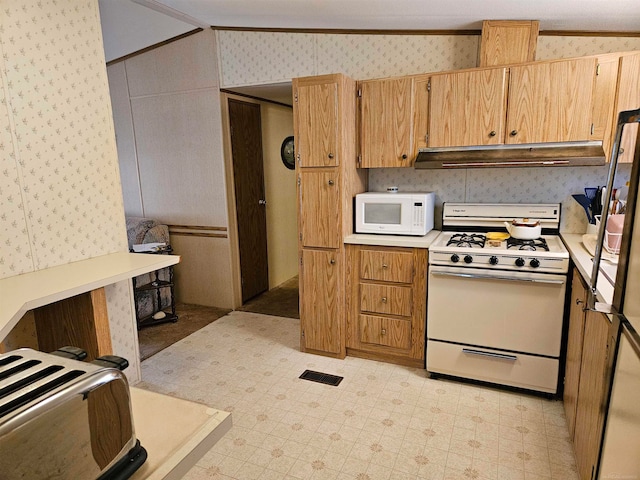 kitchen featuring crown molding, white appliances, light tile floors, and lofted ceiling