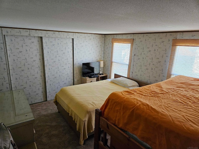 carpeted bedroom with a textured ceiling