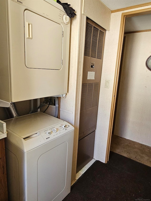 washroom featuring stacked washer and dryer