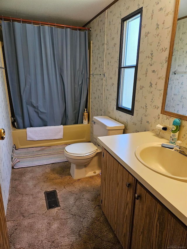 full bathroom with toilet, oversized vanity, shower / bath combo with shower curtain, and a textured ceiling