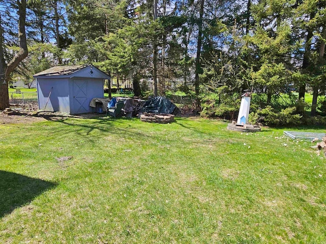 view of yard featuring a fire pit and a shed