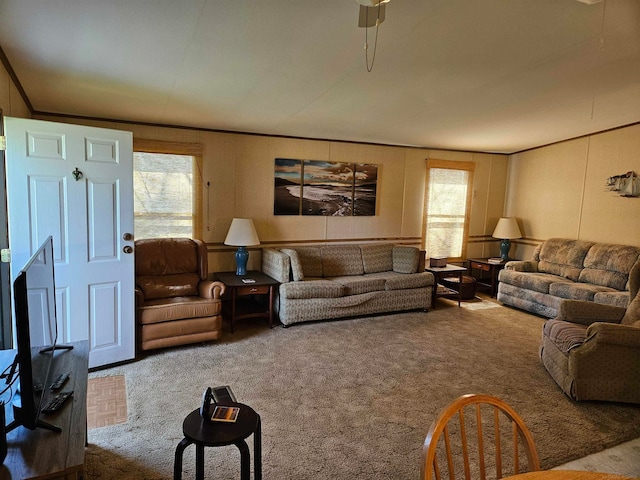 carpeted living room with ceiling fan