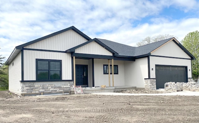 modern farmhouse with a porch and a garage