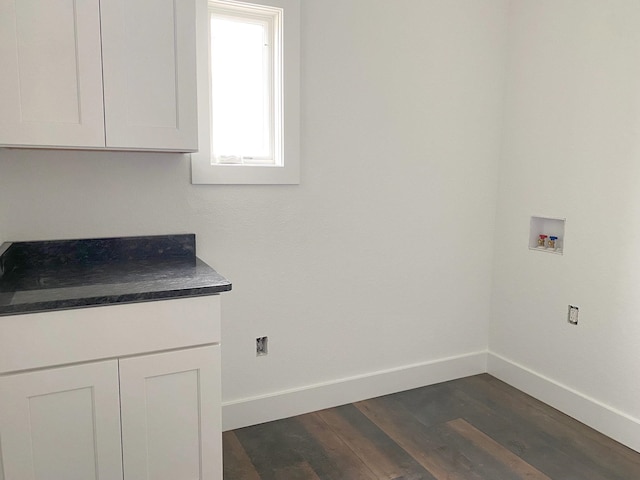 laundry room with cabinets, dark hardwood / wood-style flooring, and hookup for a washing machine