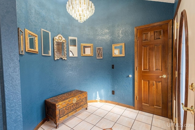 interior space with light tile patterned floors and a chandelier