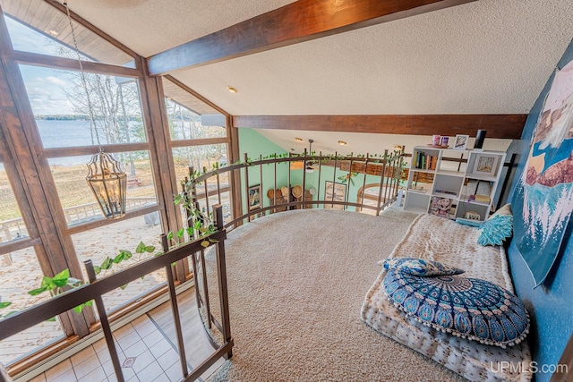 sunroom / solarium featuring a wealth of natural light, lofted ceiling with beams, and a water view