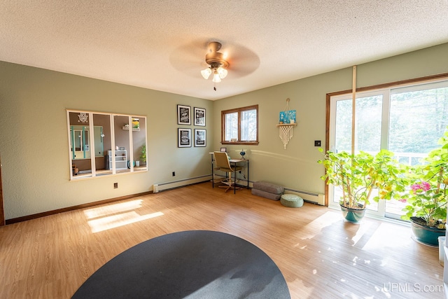 miscellaneous room with a textured ceiling, plenty of natural light, and wood-type flooring