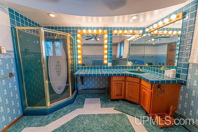 bathroom with vanity and a shower with door